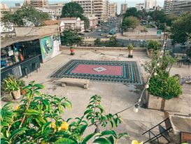 An Ornate Stenciled Rug by Mateo Complements a Cultural Center’s Communal Rooftop in Dakar