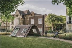 Alex Chinneck’s Playful Undulating Sculpture Looks like a Brick House Taking a Seat
